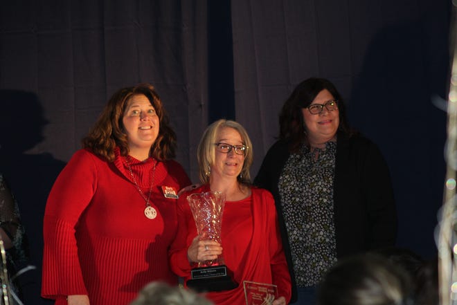 Businesswoman of the Year winner Kelly Willette (center) accepts her award at the Ionia Area Chamber of Commerce Community Awards.
