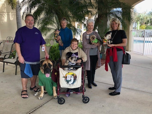 Community Hospice & Palliative Care Pet Therapy volunteers and their friendly companions at one of the organization’s pet parades. These volunteers share their companions with patients at health care facilities. [CONTRIBUTED PHOTO]