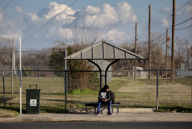 Hector Galvan, a senior at Eastside Memorial High School, waits for a Capital Metro bus to arrive at a bus stop near the school on Jan. 28. [NICK WAGNER/AMERICAN-STATESMAN]