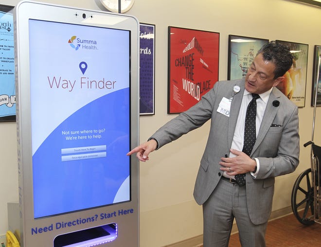 Dr. David Custodio, senior vice president of Summa Health and president of Akron City Hospital, demonstrates a kiosk that helps people find their way through the hospital campus in Akron. [Karen Schiely/Beacon Journal/Ohio.com]