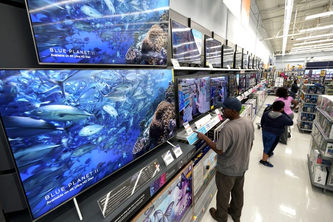 Shoppers look at televisions at a Walmart Supercenter in Houston. [AP File Photo/David J. Phillip]