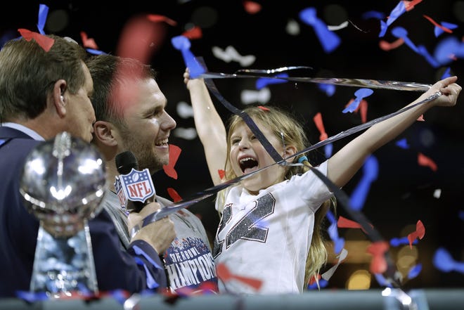 Patriots quarterback Tom Brady (middle) celebrates with his daughter, Vivian, after the Patriots' 13-3 win over the Los Angeles Rams in Super Bowl LIII on Sunday in Atlanta. [AP File Photo/David J. Phillip]