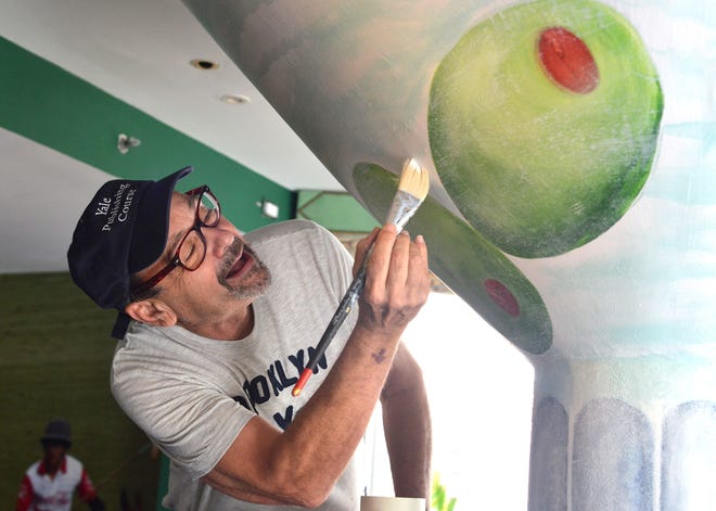 Artist Bruce Helander paints a column at The Colony in 2014. He will speak on “My Life as an Artist, Curator and Critic” Tuesday at The Chesterfield.