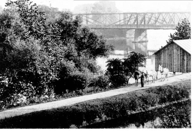 Photo courtesy of Tuscarawas County Historical Society

A Fink Truss bridge (background) spanned the Tuscarawas River at Dover for about 40 years in the 19th century and early 20th century. A portion of the bridge is still used for a hiking trail near Zoarville.