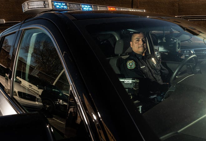 Officer Al Ballesteros sits inside a Decatur Police Department SUV on Thursday morning. After 23 years with the Decatur Police Department, he retired Friday. [Photo/Dan Busey/Decatur Daily]