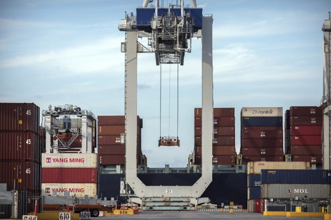 FILE- In this July, 5, 2018, file photo photo, a ship to shore crane prepares to load a 40-foot shipping container onto a container ship at the Port of Savannah in Savannah, Ga. (AP Photo/Stephen B. Morton, File)
