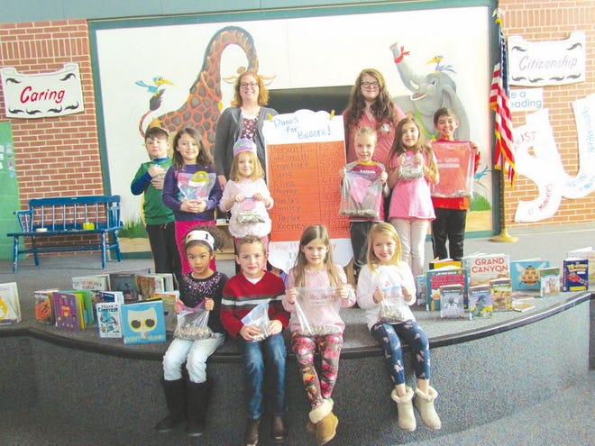 Kiely Fisher, director of the Lilian S. Besore Memorial Library, left, and Cheyenne Bookwalter, children's librarian, were on hand for the Dimes for Besore 100th day first-grade program at Greencastle-Antrim Primary School. Children who represented their class in the coin collection were, from left, seated: Izumi Bernard, Chase Cordell, Ella Worley and Maci Bishop. Standing: Thaddeus Stevenson, Eliza Bigler, Brook Thornlow, Dmitri D'Amore, Anna Biamonte and Noah Ambrose. SHAWN HARDY/ECHO PILOT