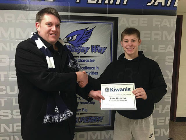 Kiwanis President Jeremy Winter gives the January Student of the Month certificate to Kaleb Olejniczak . PHOTO SUBMITTED TO THE PERRY CHIEF