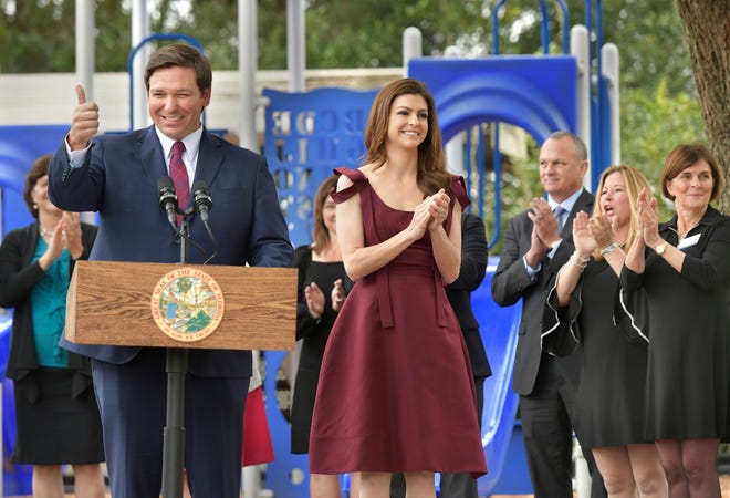 Florida Gov. Ron DeSantis gives a thumbs up after announcing he is ending a waiting list for special education scholarships as first lady Casey DeSantis applauds Monday, Feb. 4, 2019 at the North Florida School of Special Education in Jacksonville, Fla. (Will Dickey/The Florida Times-Union via AP)