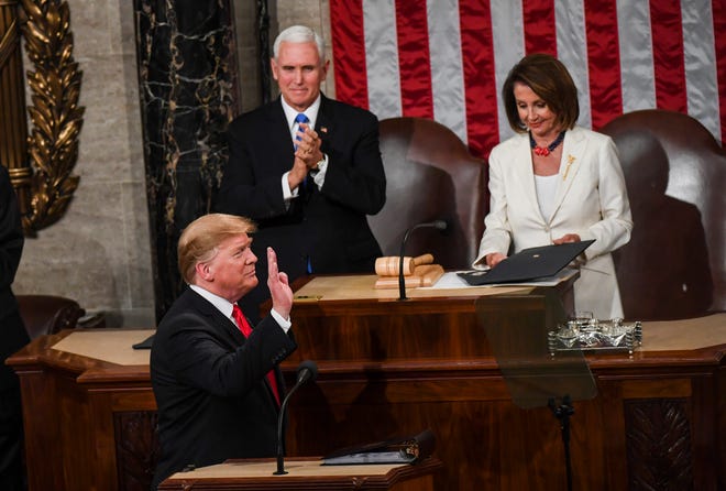 President Donald Trump arrives, in front of Vice President Mike Pence and House Speaker Nancy Pelosi, D-Calif., for the State of the Union address before members of Congress in the House chamber of the U.S. Capitol. MUST CREDIT: Washington Post photo by Toni L. Sandys