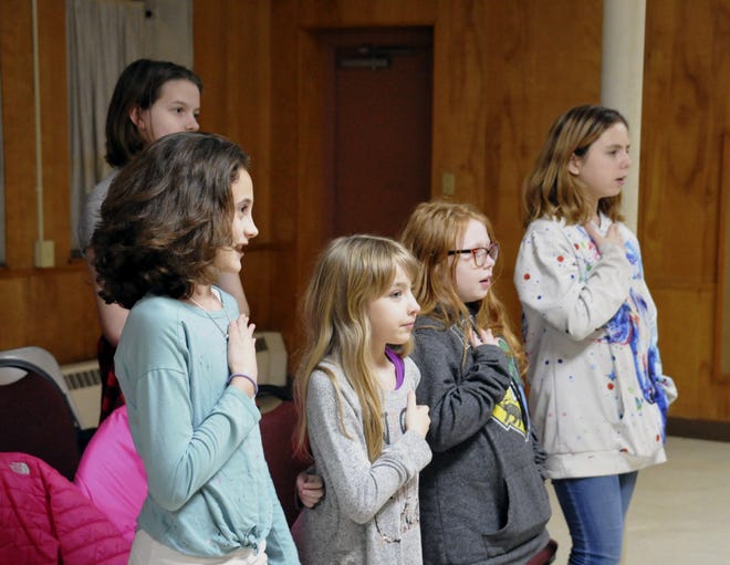 Kailey Kartisek (left), Rowan Craft, Amelia Howard and Elizabeth Cole state the pledge of allegience to start the meeting. (GateHouse Media Ohio / Mike Schenk, The-Daily-Record.com)