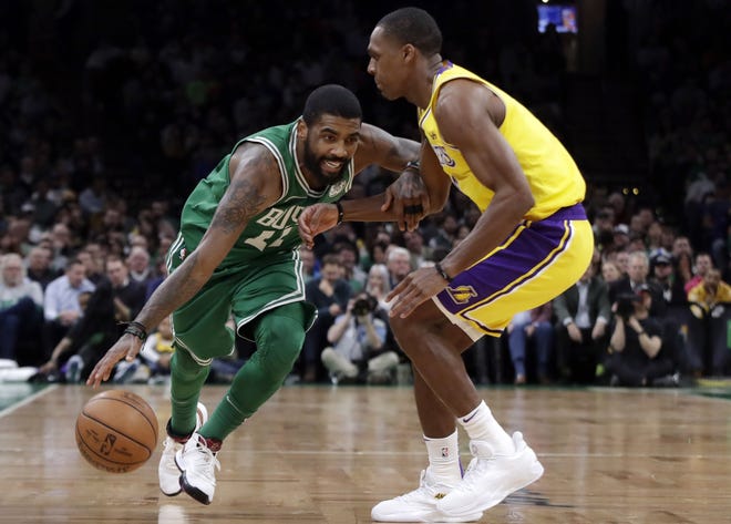 Celtics guard Kyrie Irving (left) drives against Lakers guard Rajon Rondo in the first quarter of Boston's 129-128 loss to Los Angeles. Rondo would end up hitting the game winning shot for the Lakers at the buzzer. [AP Photo/Elise Amendola]
