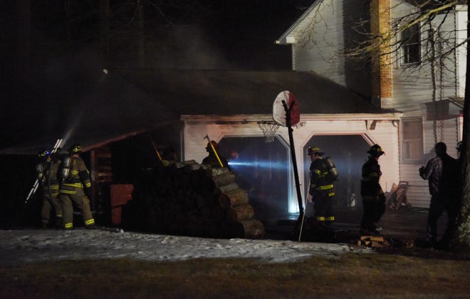 Firefighters work to extinguish a garage fire at 265 Farmer Bush Road in Stroud Township on Thursday, Feb. 7, 2019. According to police on scene, the family that occupies the residence was home at the time of the fire but nobody was injured. [PATRICK CAMPBELL/POCONO RECORD]