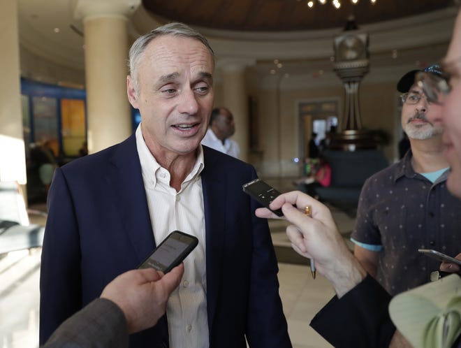 Rob Manfred, commissioner of Major League Baseball, talks to reporters at the end of the day's conferences at MLB baseball owners meetings Thursday, Feb. 7, 2019, in Orlando, Fla. (AP Photo/John Raoux)