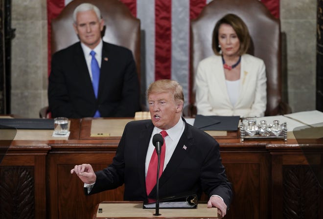 President Donald Trump delivers his State of the Union address to a joint session of Congress on Capitol Hill in Washington on Tuesday as Vice President Mike Pence, left, and Speaker of the House Nancy Pelosi, D-Calif., watch. [AP PHOTO/CAROLYN KASTER]