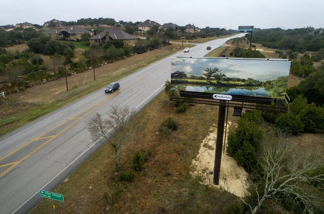 A billboard towers near Driftwood along RM 1826 at Darden Hill Road. A bill by state Rep. Erin Zwiener, D-Driftwood, would prevent other billboards from going up along 1826 and on along parts of RM 150 and RM 967, although existing billboards could stay. [JAY JANNER/AMERICAN-STATESMAN]