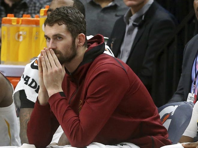 Cleveland Cavaliers' Kevin Love watches from the bench in the second half of a game against the Minnesota Timberwolves. [Jim Mone/Associated Press]