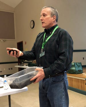 Ret. Yarmouth Police Chief Mike Almonte is also a master gardener. In his recent talk about composting, he shows off his well-composted soil. [BP PHOTOS BY MARINA DAVALOS]