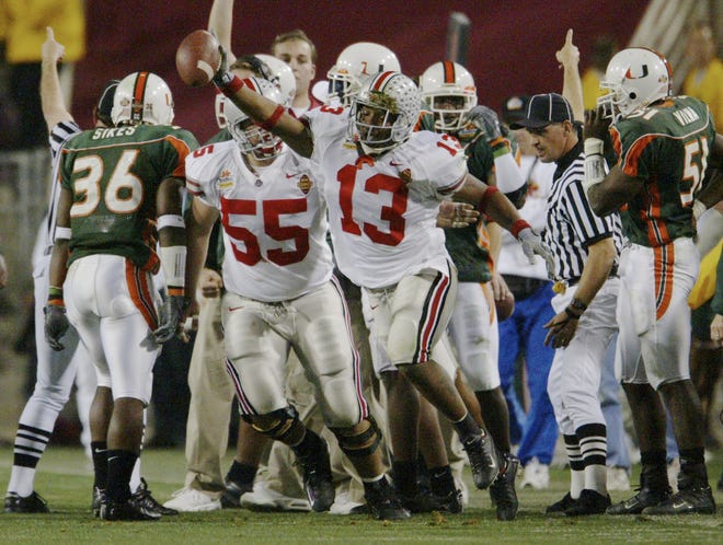 The Buckeyes' Maurice Clarett emerges from the pack with the ball after stripping it from Sean Taylor, after the Hurricanes safety had intercepted OSU's Craig Krenzel in the end zone during the national championship game at the Fiesta Bowl in 2003. [Dispatch file photo]