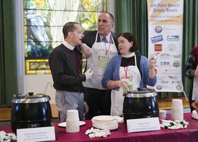 From left, The Rev. James Harlan of The Episcopal Church of Bethesda-by-the-Sea, Rabbi Michael Resnick of Temple Emanu-El and the Rev. Margaret McGhee of Bethesda join together to serve soup during the annual Palm Beach Empty Bowls event Friday at Bethesda. [Photos by Meghan McCarthy/palmbeachdailynews.com]