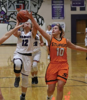 Three Rivers’ Aislyn Sternbergh drives up for a layup around the defense of Taylor Hopkins of Sturgis on Friday night.