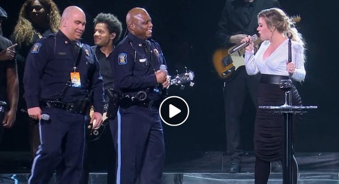 Kansas Capitol Police Officers LaMont Jackson and Michael Pagel, who have become known on social media for their version of carpool karaoke, sang “Stand By Me” by Ben E. King, on Thursday night at Kelly Clarkson's concert in Kansas City, Mo. [Facebook/Kelly Clarkson]
