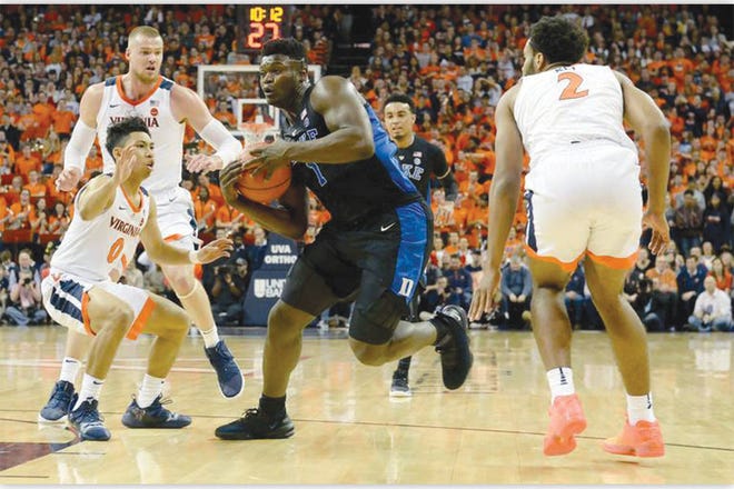 SCORING SAVANTS — Duke’s Zion Williamson drives to the basket past Virginia’s Kihei Clark (0). Duke’s 81-point output was the most in regulation by any Virginia opponent since Dec. 2013.