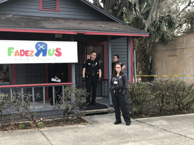 Ocala police officers are shown at the scene of a shooting Saturday at Fadez R Us Hair Studio, 1514 N. Magnolia Ave., in which an arugment between two men led to one being shot and taken to a local hospital. Police were interviewing everyone at the scene of the shooting, which happened shortly after 4 p.m. Saturday. [Austin L. Miller/Staff]