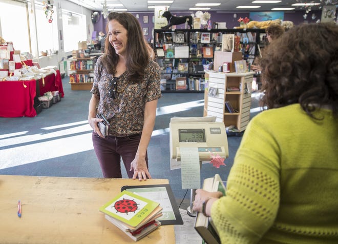 Bethany Morrison purchases 11 books at Recycled Reads, the city-owned book store in North Austin, in December. The store sells roughly 12,000 books a month at prices that range from 50 cents to $1. [RICARDO B. BRAZZIELL/AMERICAN-STATESMAN]