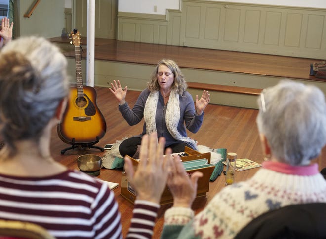 Sound therapist Rosemary Warburton shares a moment of love and peace with the Newport Community Chanting Group at St. Paul's Methodist Church on Saturday. The event celebrated World Sound Healing Day. [PETER SILVIA PHOTO]