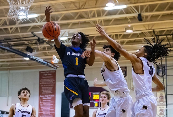 Pflugerville Panthers guard Dwayne Taylor (1) draws a foul by Rouse Raiders forward Jake Lilley (11) during the second period at the District 17-5A boys basketball game Feb. 8 at Rouse High School. [JOHN GUTIERREZ / FOR AMERICAN - STATESMAN]