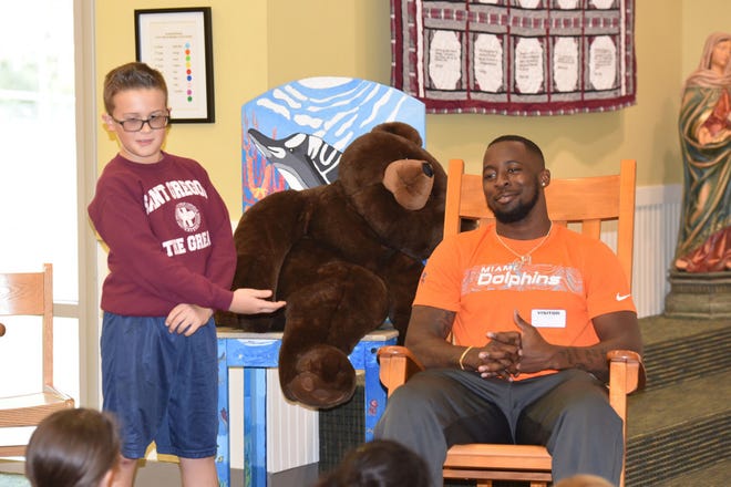 Fifth-grade student Carson Lonz introduces Miami Dolphins cornerback Dee Delaney to his St. Gregory classmates. [Photo courtesy of Mary Beth Lyons]