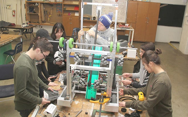 Hillsdale High School robotics team members Spencer Parker, Katherine Knecht, Wendy Liu, Drew Pitts, Kyler Beutista and Moey Tanelkongtung work on this year’s robot Saturday morning. [ANDY BARRAND/Hillsdale Daily News]