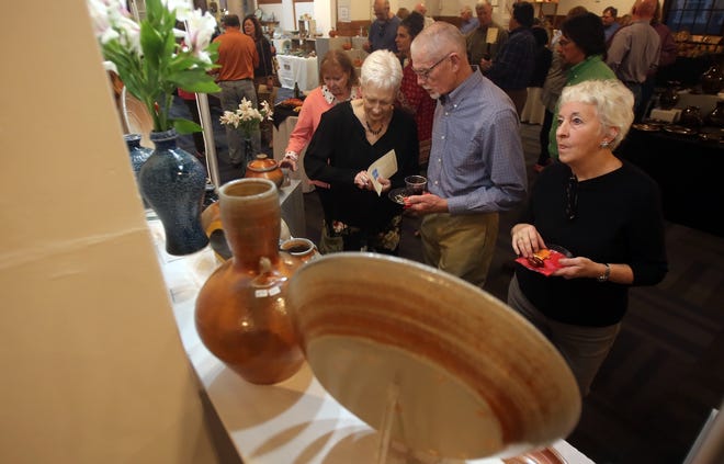 People view pottery at the 24th annual Treasures of the Earth Pottery Show and Sale on Thursday. [Brittany Randolph/The Star]