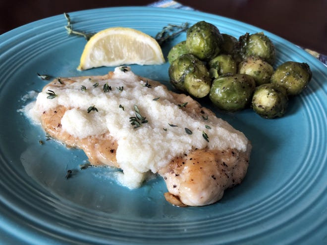 Pan-seared chicken is topped with a cauliflower cream sauce and fresh thyme, served alongside seasoned steamed Brussel sprouts — a filling, healthy and delicious plate that fits within Paleo diet parameters. [JAN WADDY/THE NEWS HERALD
