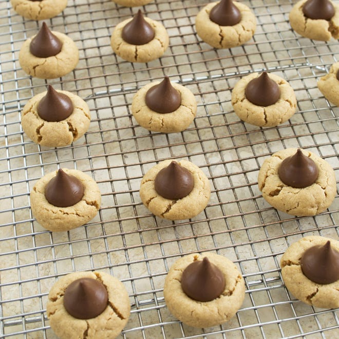 This Peanut Blossom Cookies recipe appears in the cookbook "Perfect Cookie." (Daniel J. van Ackere/America's Test Kitchen via AP)