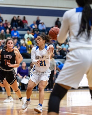 Pflugerville senior guard Kiera King drives and passes to a teammate. Pflugerville won a bi-district girls playoff game against Hutto 80-46 on Feb. 11 at Hendrickson High School. [Henry Huey for American-Statesman.]