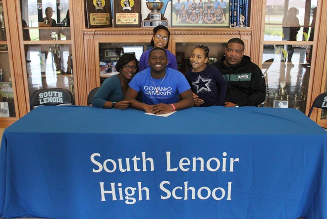 South Lenoir defensive lineman T.J. Miller (center) signed his national letter of intent to play football at Chowan on Monday. He was joined by (from left to right) his mother, Dana, his sisters, Anya and Kyndall, and his father Terrence. [
Laieke Abebe/Free Press]