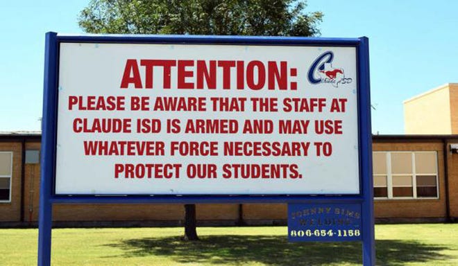 This August 2016 photo shows a sign outside a school in Claude, Texas. A Florida Senate panel tasked with shaping statewide education policies advanced a sweeping school-security package on Tuesday that would make it easier for school districts to participate in a controversial “guardian” program and would allow classroom teachers to be armed. [Creede Newton / Amarillo Globe-News via AP]
