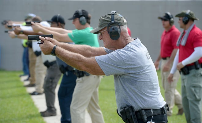 Donald Allen, a former Florida Highway Patrolman, (foreground) and others participate in the first day of firearms training for the initial class of Polk Public School's Safety Guardian program in June of 2018. The 25 sheriff’s offices participating in the school guardian program have spent nearly $2 million to buy firearm supplies and at least $3 million to pay for salaries and the training process.

 [GateHouse Media File]