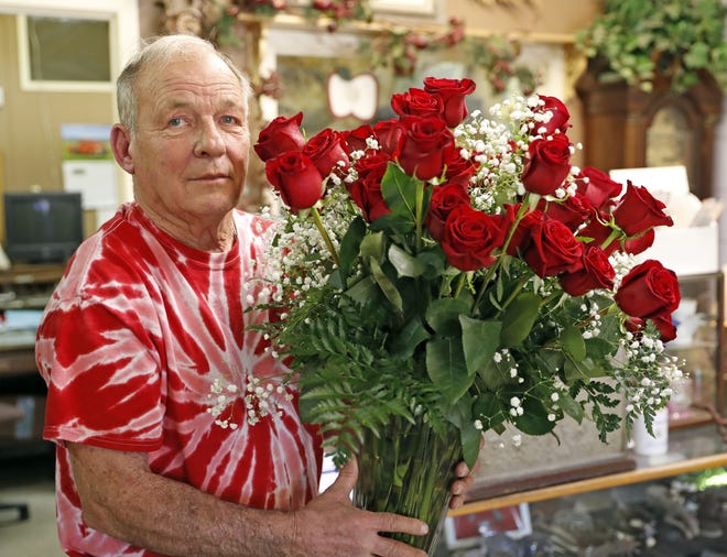 Mickey Sharp, owner of Flowers Etc., holds a floral arrangement of roses and baby's breath for a Valentine's Day client, Tuesday, Feb. 12, 2019, at Flowers Etc. in Lubbock, Texas. [Brad Tollefson/A-J Media]
