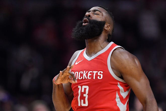 Houston Rockets guard James Harden celebrates after hitting a 3-point shot during the first half of an NBA game against the Los Angeles Clippers in Los Angeles. [AP PHOTO/MARK J. TERRILL]