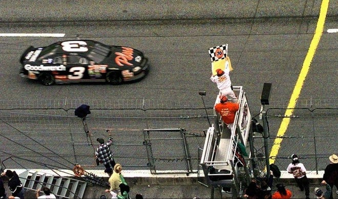 Dale Earnhardt Sr. takes the checkered flag to win the 1998 Daytona 500. [ASSOCIATED PRESS FILE PHOTO]