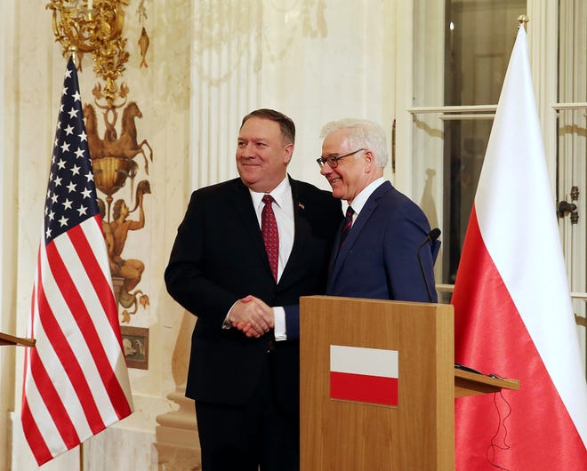 Polish Foreign Affairs Minister Jacek Czaputowicz,right, and US Secretary of State Mike Pompeo shake hands at a news conference at Lazienki Palace, Warsaw, Poland, Tuesday, Feb. 12, 2019. (AP Photo/Czarek Sokolowski)