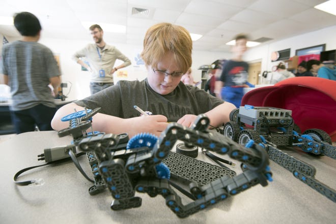Skylor Vollkommer, 11, begings to design and build a robot for the Somersworth Middle School robotics team Thursday. [John Huff/Fosters.com]