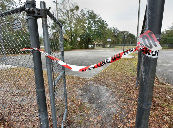 Crime-scene tape remains Friday morning following a shooting Thursday night at this city park basketball court on Redpoll Avenue in Northwest Jacksonville. Two people were killed and two more wounded in the shootout. [Will Dickey/Florida Times-Union]