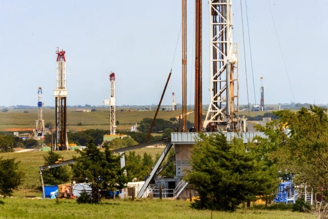 Rigs drill wells in the SCOOP play of the Anadarko Basin near Chickasha in 2018. [THE OKLAHOMAN ARCHIVES]