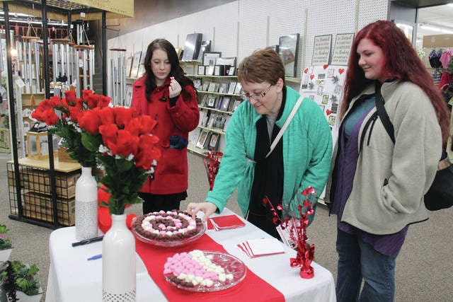 Shoppers, from left, Caitlin Friedrichsen, Melissa Landon and Elizabeth Landon, sample the chocolate mints at Ben’s Five and Dime on Saturday, Feb. 9. PHOTO BY ALLISON ULLMANN/THE PERRY CHIEF