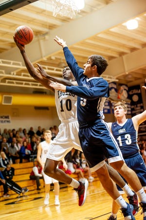 Fayetteville Academy's Emmanuel Izunabor scores a layup against Wayne Christian in the second round of the NCISAA 2-A playoffs on Thursday, at Fayetteville Academy. [Raul F. Rubiera/The Fayetteville Observer]