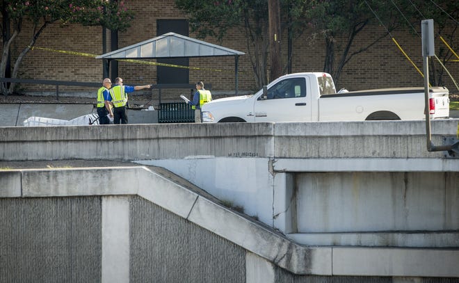 Austin police officers investigate at the scene where a driver hit and killed a pedestrian on Ben White Boulevard near South First Street on Aug. 1. [JAY JANNER / AMERICAN-STATESMAN]